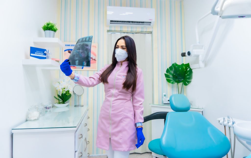An Emergency dentist reading dental x ray